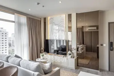 Luxurious modern living room with elegant decor and large windows offering city views.