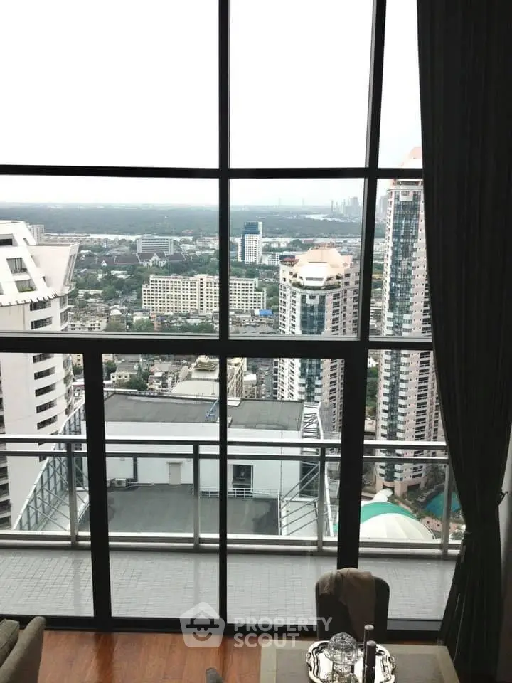 Stunning high-rise apartment with floor-to-ceiling windows offering breathtaking city views.