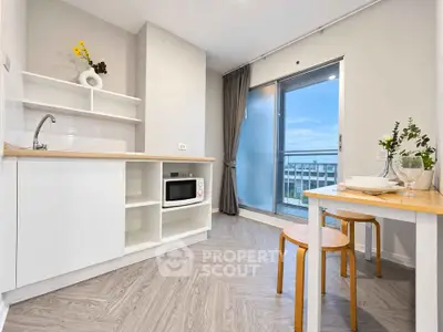 Modern kitchen with open layout and balcony view in stylish apartment