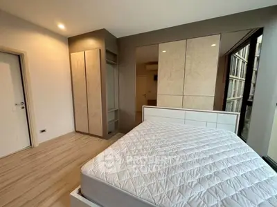 Modern bedroom with sleek design and large mirrored wardrobe