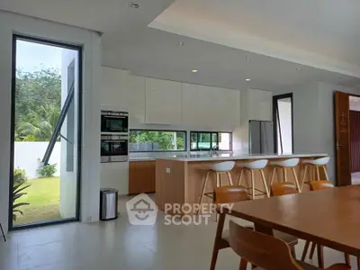 Modern kitchen with sleek design, featuring a large island and open layout, perfect for entertaining.
