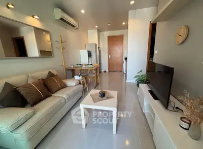 Modern living room with cozy sofa, stylish decor, and sleek TV setup.