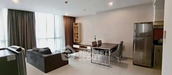 Spacious modern living room with dining area and natural light in a stylish apartment.