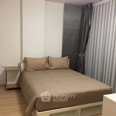 Cozy bedroom with modern decor and neutral tones, featuring a comfortable bed and stylish curtains.