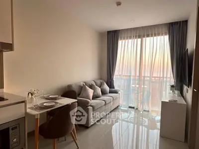 Modern living room with sunset view, cozy sofa, and elegant dining setup.