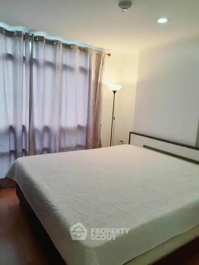 Cozy bedroom with soft lighting and elegant curtains