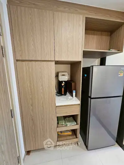Modern kitchen with sleek wooden cabinets and stainless steel fridge