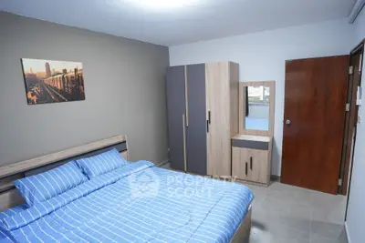 Modern bedroom with stylish furniture and blue bedding in a cozy apartment