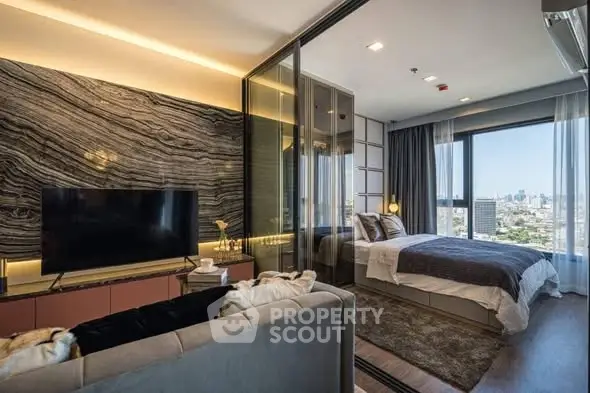 Luxurious modern living room with glass partition to bedroom and stunning city view.