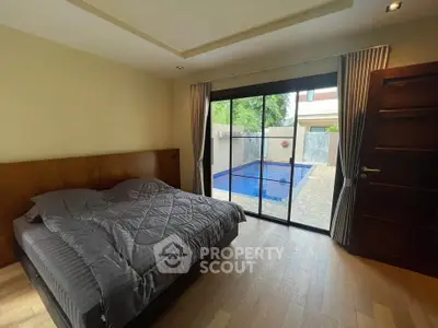 Luxurious bedroom with pool view and elegant wooden flooring
