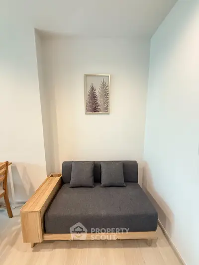Modern minimalist living room with stylish grey sofa and wooden accents