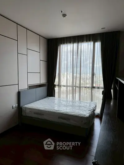 Modern bedroom with large window and stylish decor
