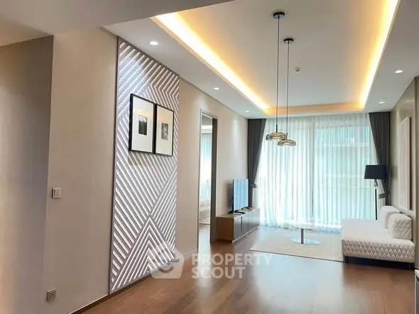 Modern living room with stylish decor and large windows offering natural light.