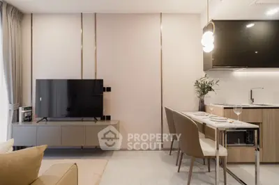 Modern living room with sleek TV setup and elegant dining area