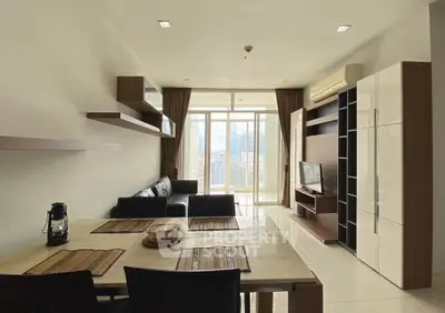 Modern living room with city view, sleek furniture, and open layout in high-rise apartment.