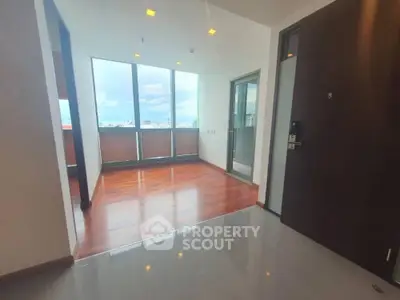 Spacious corner unit with gleaming floors and abundant natural light, featuring a large balcony with panoramic views, ideal for upscale urban living.