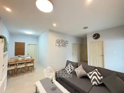 Modern living room with stylish decor and cozy dining area in open layout apartment.