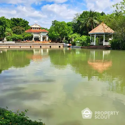 Stunning lakeside view with charming gazebo and lush greenery, perfect for serene living.