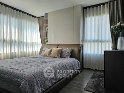 Luxurious bedroom with elegant decor and natural light, featuring a plush bed and stylish curtains.