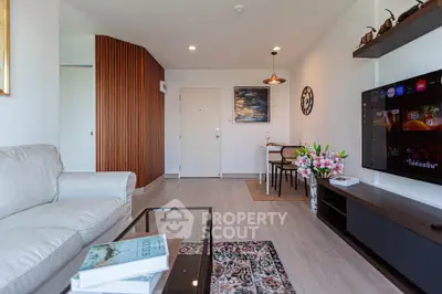 Modern living room with stylish decor, cozy sofa, and entertainment center in a contemporary apartment.