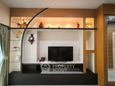 Modern living room with stylish TV unit and decorative shelves, perfect for contemporary homes.