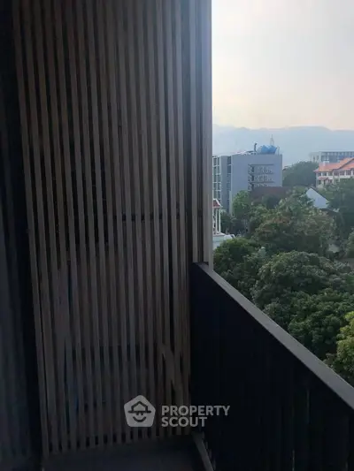 Charming balcony with scenic city view and lush greenery, perfect for relaxation and enjoying the outdoors.