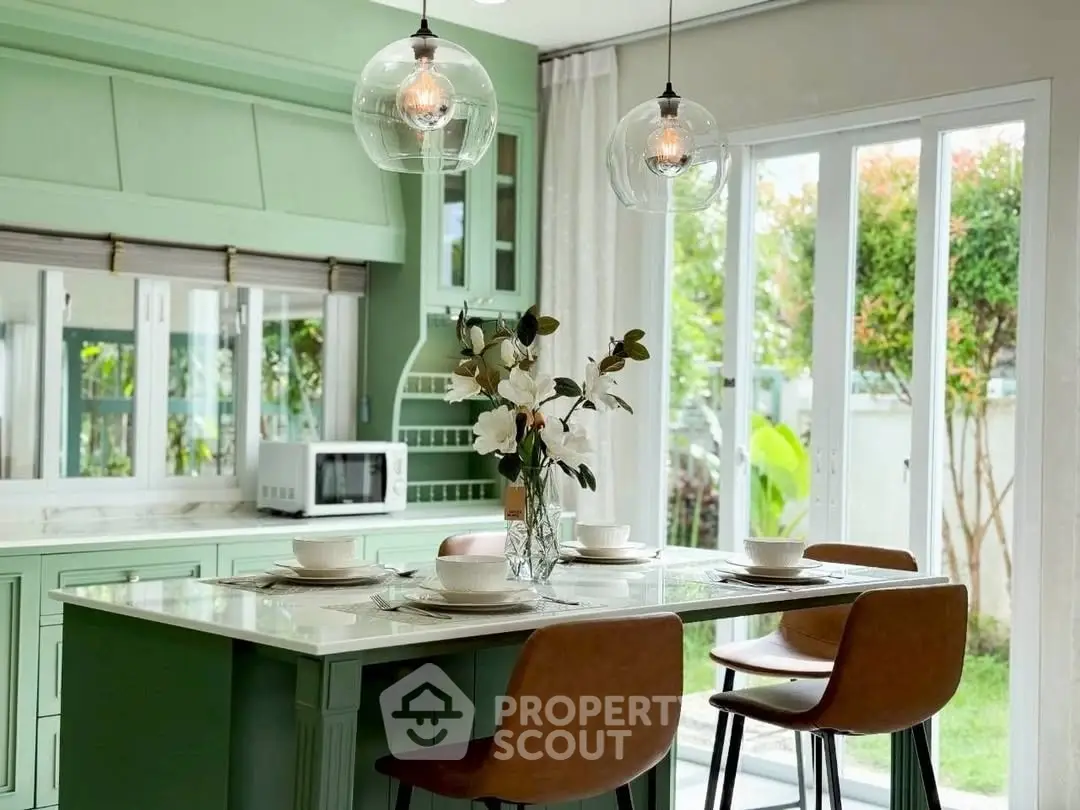 Chic modern kitchen with green cabinets and stylish dining area