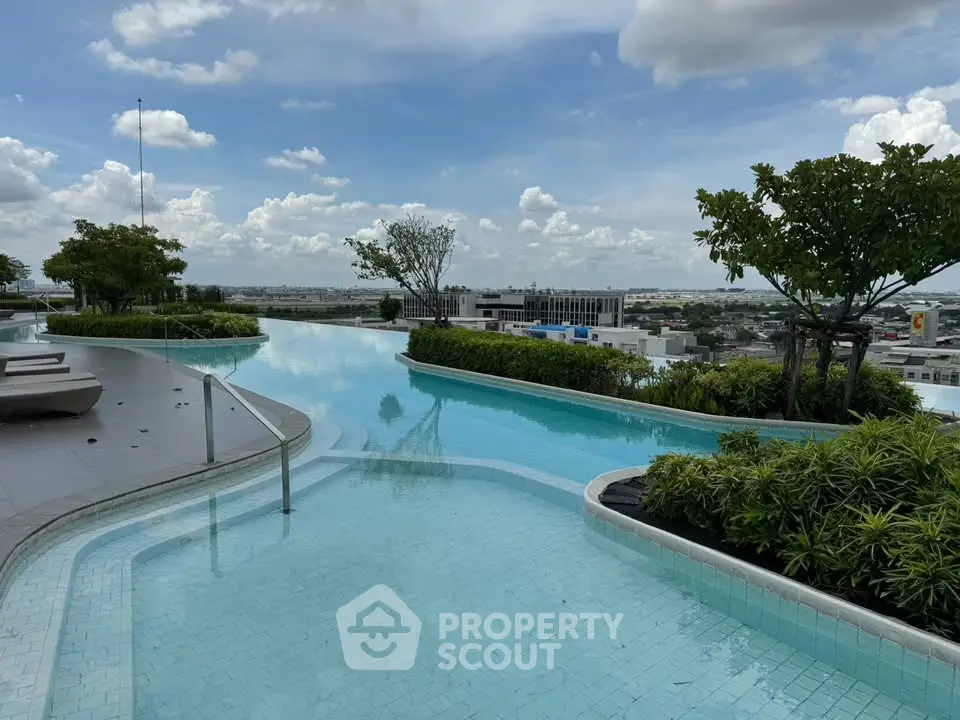 Stunning rooftop pool with panoramic city views and lush greenery