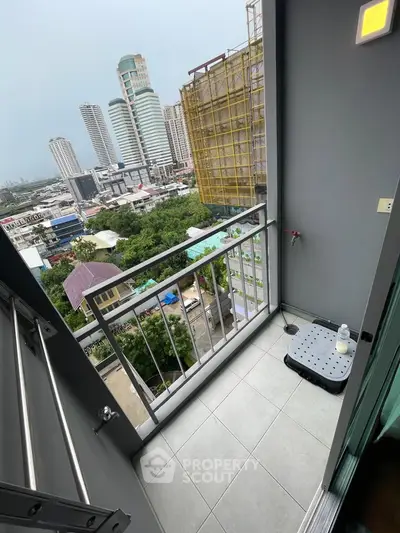 Modern balcony with city view in high-rise apartment, featuring sleek design and urban landscape.