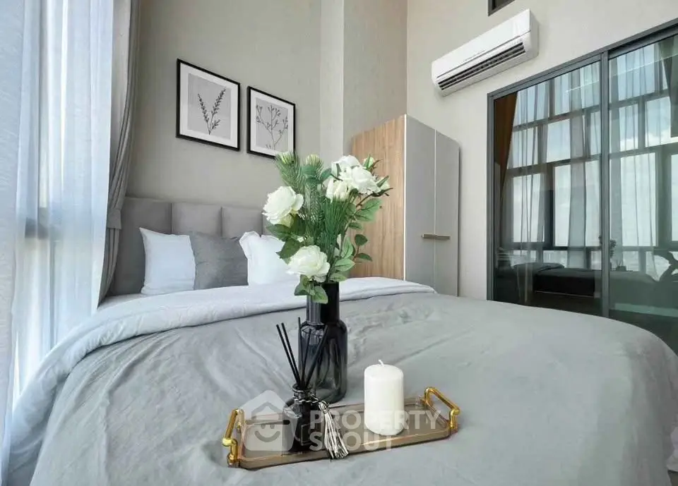 Modern bedroom with elegant decor and large windows offering natural light.