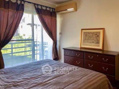 Cozy bedroom with elegant dresser and balcony view