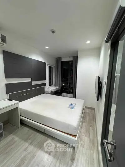Modern minimalist bedroom with sleek design and city view