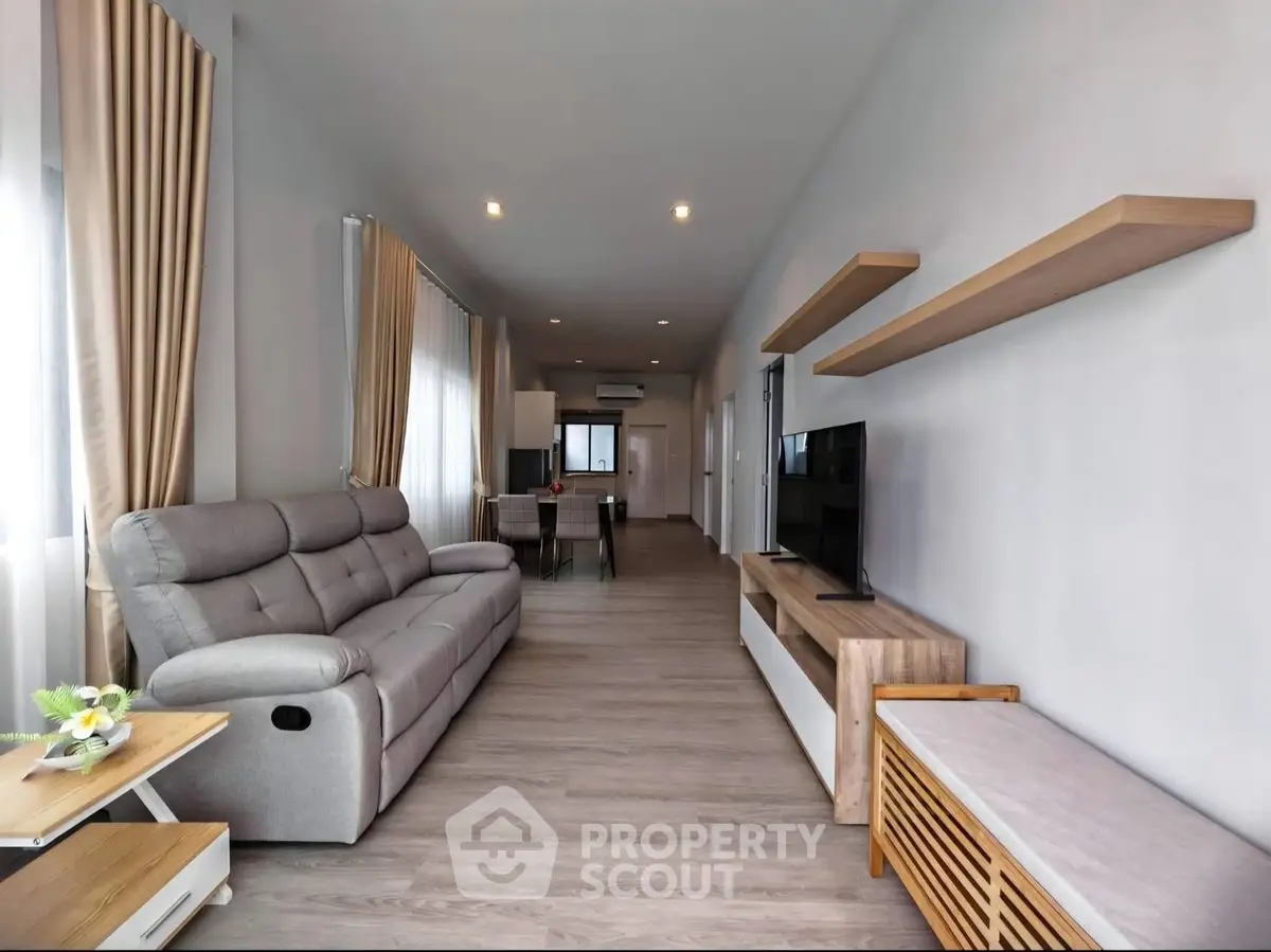 Spacious modern living room with sleek furniture and natural light