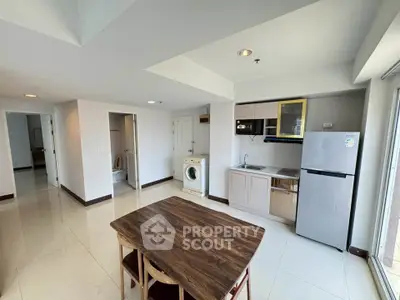 Spacious open-plan kitchen and dining area with modern appliances and natural light.
