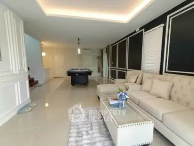 Luxurious living room with elegant decor and pool table, perfect for entertainment and relaxation.