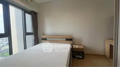 Modern bedroom with large windows and minimalist furniture in high-rise apartment