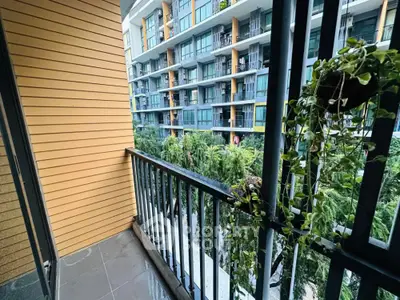 Charming balcony with lush greenery view in modern apartment complex