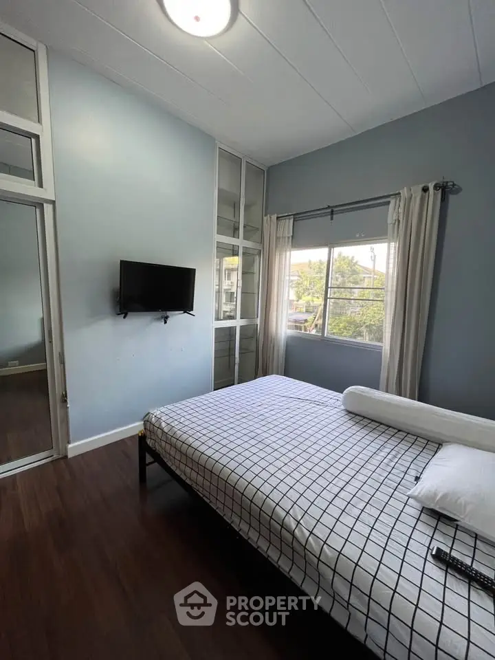 Cozy bedroom with modern decor and large window view