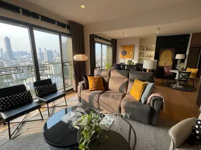 Spacious living room with city view, modern decor, and large windows in a high-rise apartment.