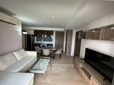 Modern living room with open kitchen and stylish furniture