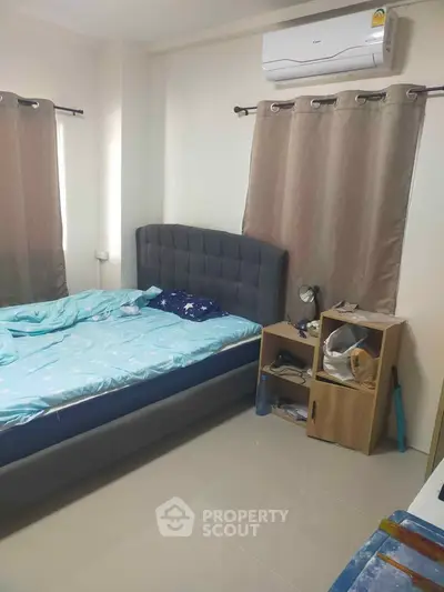 Cozy bedroom with modern bed and air conditioning, ideal for comfortable living.