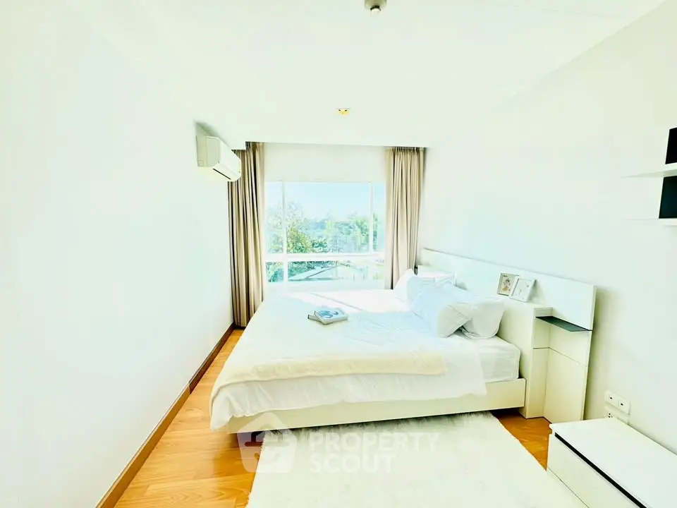 Bright and airy bedroom with large window and modern decor