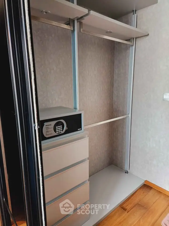 Spacious walk-in closet with secure safe and ample storage space