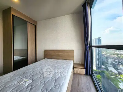 Modern bedroom with large window offering stunning city view in high-rise apartment