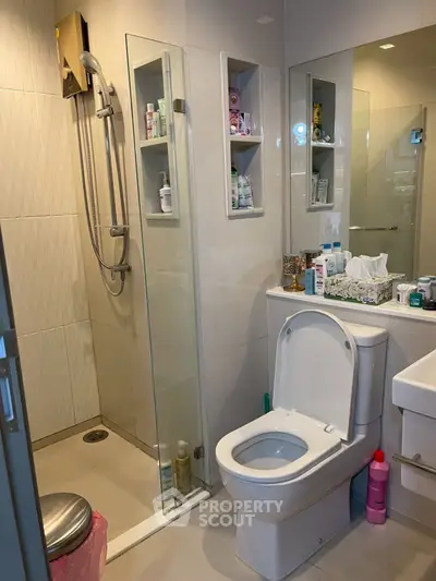 Modern bathroom with glass shower and sleek fixtures, ideal for contemporary living.