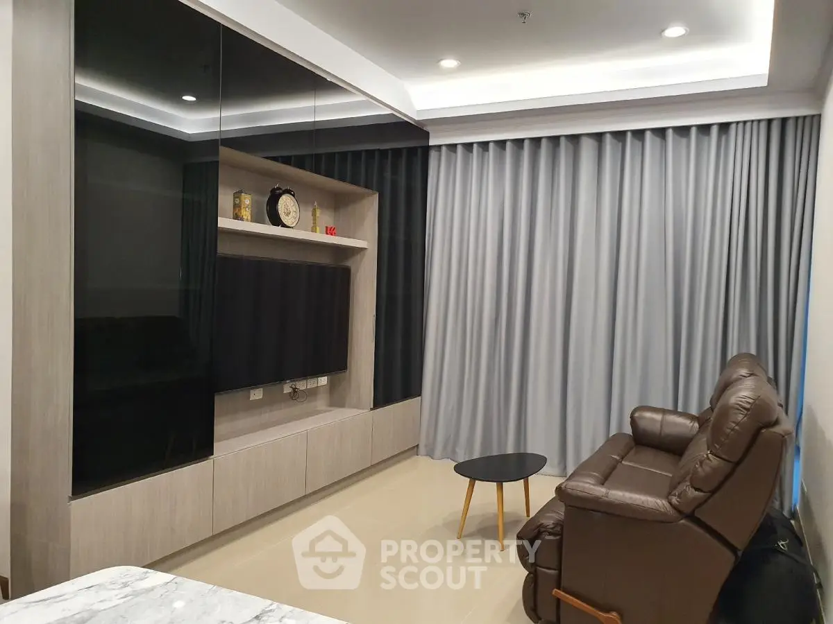 Modern living room with sleek entertainment unit and cozy leather recliner
