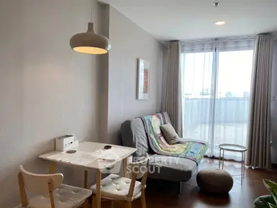 Cozy living room with modern decor and natural light from large window