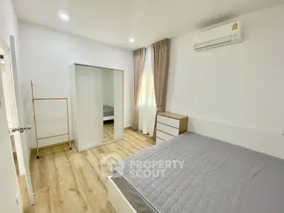 Modern bedroom with minimalist decor and natural light