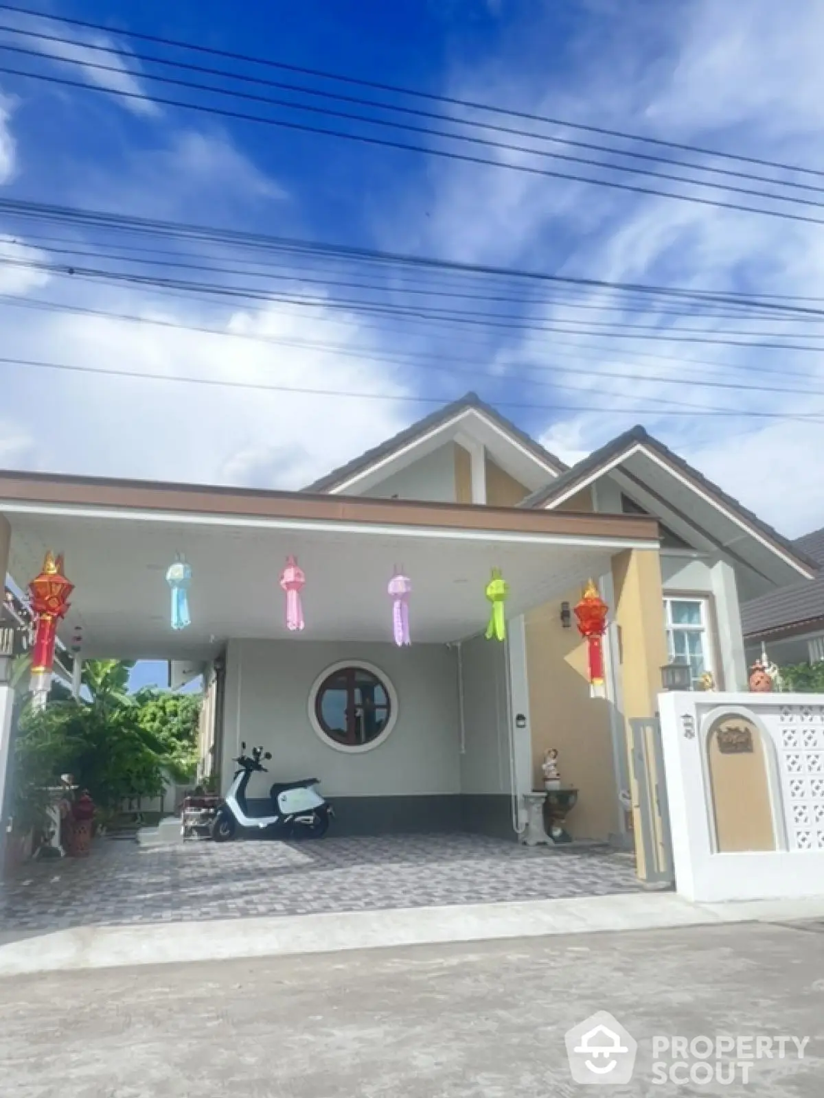 Charming single-story house with decorative lanterns and spacious driveway