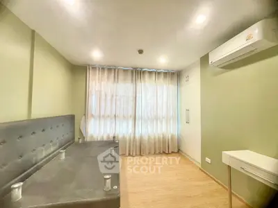Spacious bedroom with modern air conditioning and ample natural light